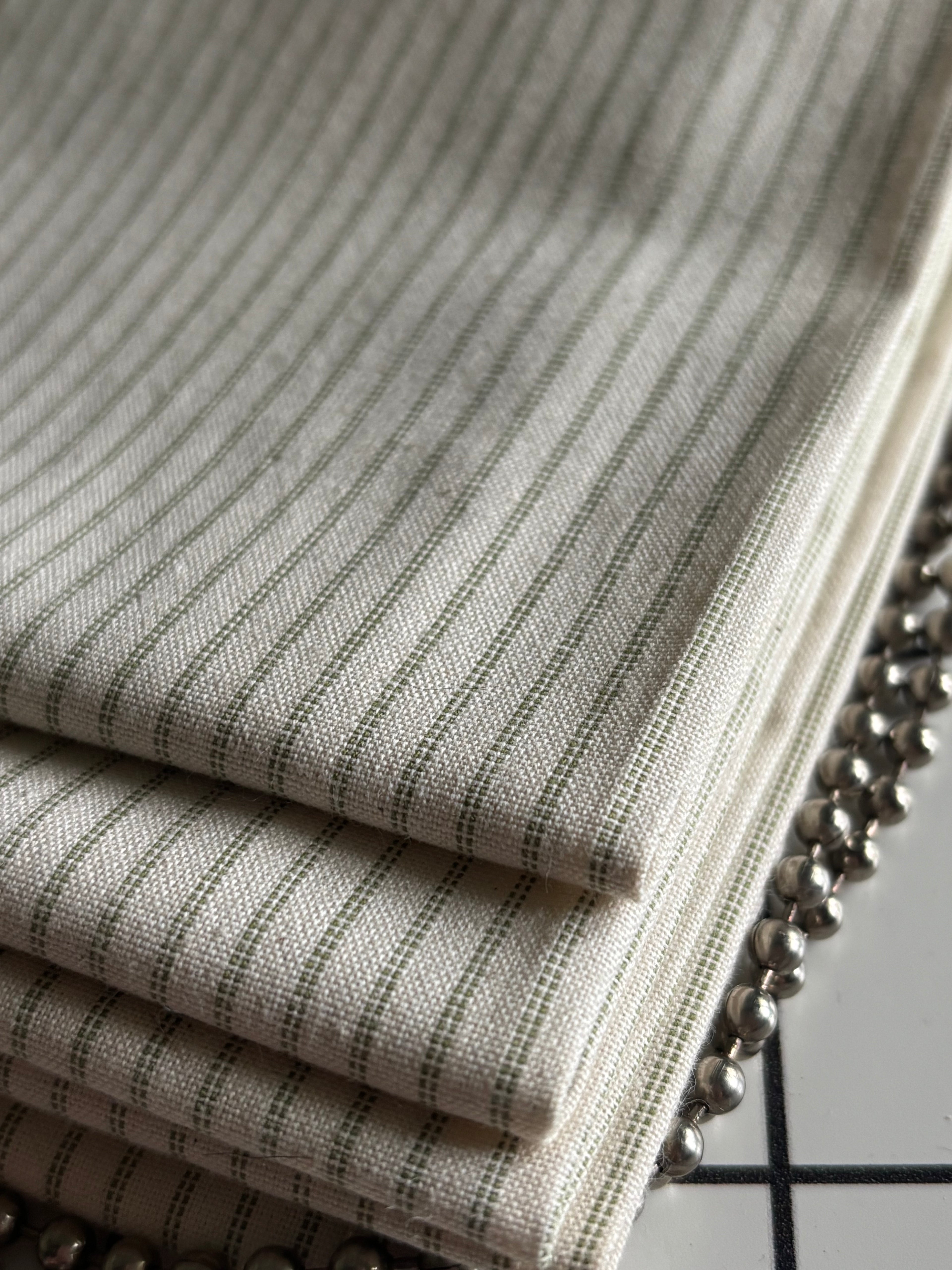 Close-up of a textured fabric with a zipper, showing details of the material and hardware.